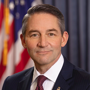 man wearing suit with red tie