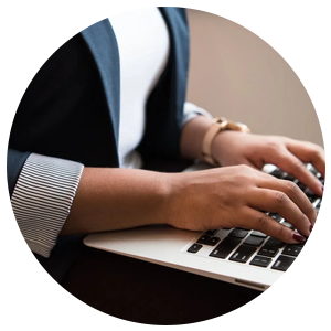 a woman typing on a laptop